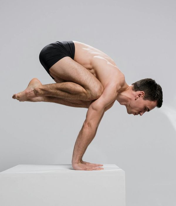 Man practicing stability and strength movements indoors