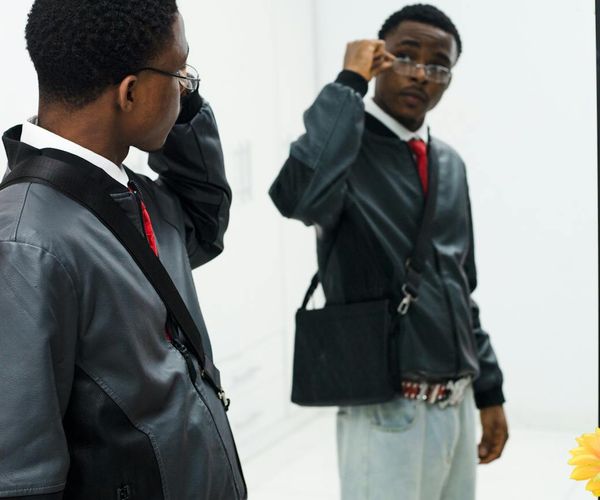 Man standing confidently in a bright room